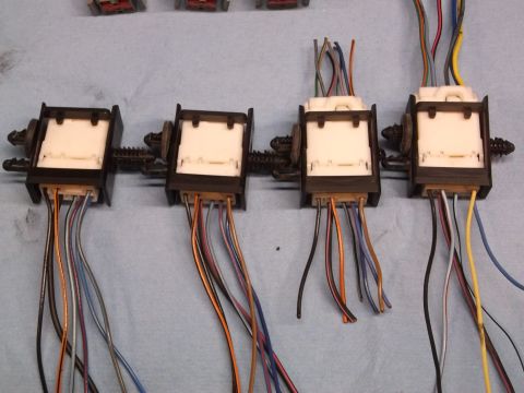 1999 Mercury Grand Marquis - Close-up of automotive wiring harnesses and connectors laid out on a blue surface.