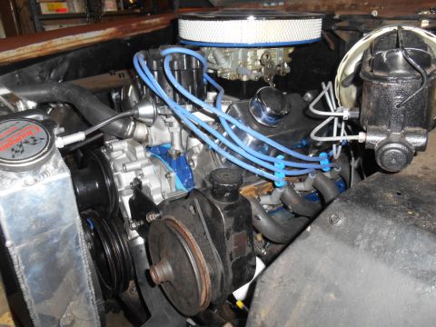 1972 Ford Bronco - Close-up view of a vehicle's engine bay, highlighting the spark plug wires and air intake system.