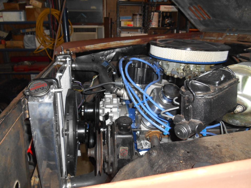 Engine bay showing a V8 engine, aftermarket radiator, and air filter