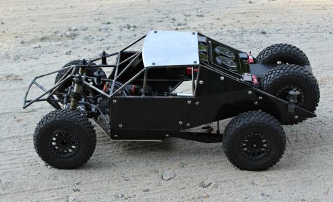 1986 Ford Bronco - This remote control buggy features a robust roll cage, off-road tires, and a spare tire mounted on the rear.