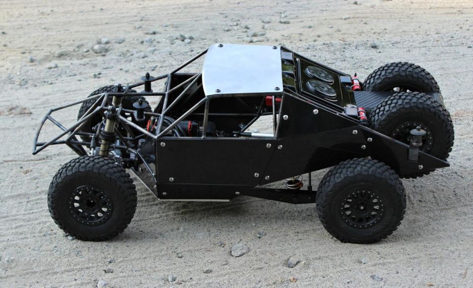 Black remote control off-road buggy with exposed roll cage and dual rear tires