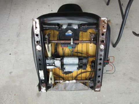 Car seat underside with exposed motors and wiring