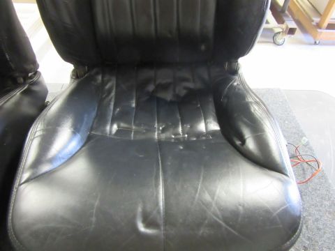 black leather car seats, one is partially visible on the left