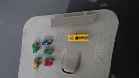 1998 Lincoln Mark VIII - Fuse box cover with several fuses and a yellow fuse removal tool. The cover includes instructions to consult the owner's manual for a fuse…
