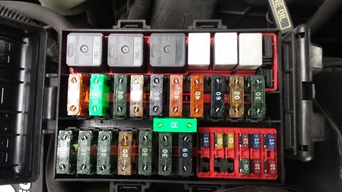 1998 Lincoln Mark VIII - Close-up of a car's fuse box, showing various relays and fuses.