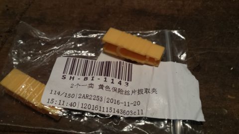 1998 Lincoln Mark VIII - A yellow fuse puller tool is shown with its packaging, which includes a barcode and product information.