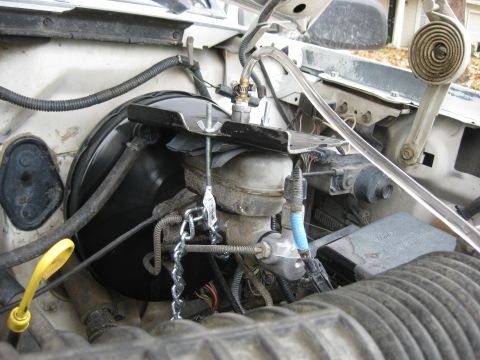 1994 Ford Bronco - Close-up of a vehicle's brake master cylinder and vacuum booster assembly.