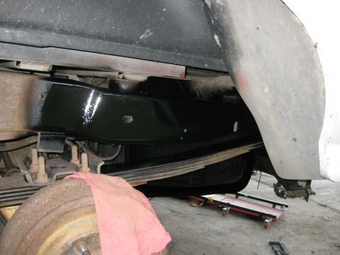 1994 Ford Bronco - The underside of a vehicle shows a recently painted frame section and suspension components.