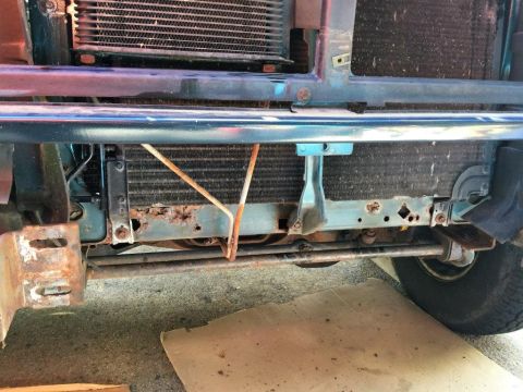1995 Ford Bronco - The radiator support shows significant rust and damage, indicating potential structural issues.