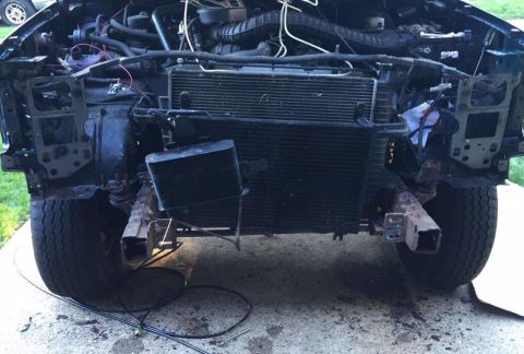 1995 Ford Bronco - The front of a disassembled SUV, likely from the 1990s, with the radiator and engine exposed.