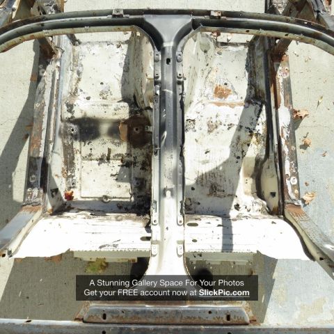 1976 Chevrolet Corvette - This is the bare chassis and frame of a car, showing significant rust and wear.