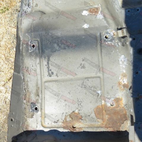 1976 Chevrolet Corvette - This heavily corroded car floor pan shows significant rust damage and wear.