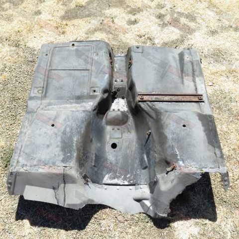 1976 Chevrolet Corvette - Underside view of a car's floor pan, showing rust and damage.