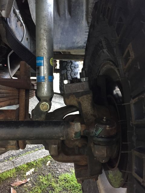 1994 Ford Bronco - Detail of the suspension system and tire of a vehicle, with a visible Bilstein shock absorber.