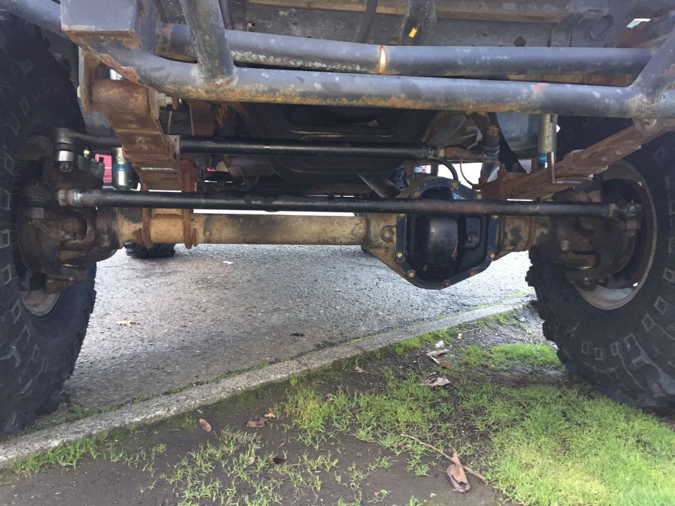 Undercarriage view of a 4x4 with leaf springs and differential visible