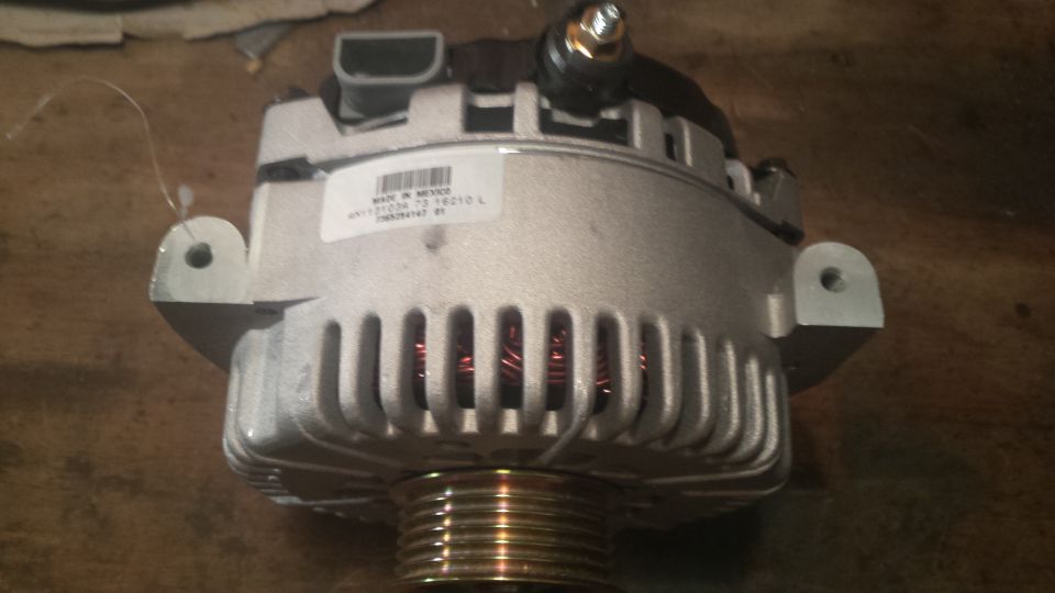 Silver alternator with "MADE IN MEXICO" sticker and visible copper windings.