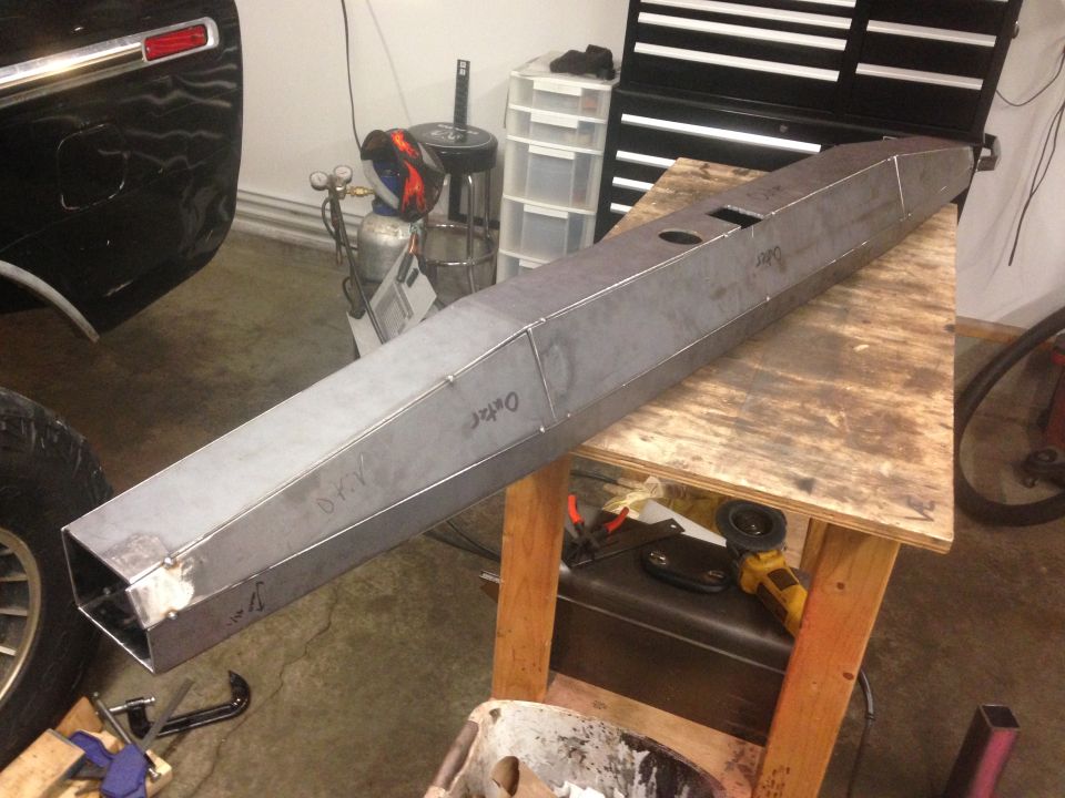 Custom steel bumper on a workbench, ready for welding.