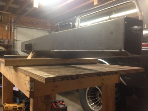 1979 Ford Bronco - A custom metal bumper or storage box is shown mounted to the rear of a vehicle, possibly a Ford Bronco, in a garage setting. The vehicle is…