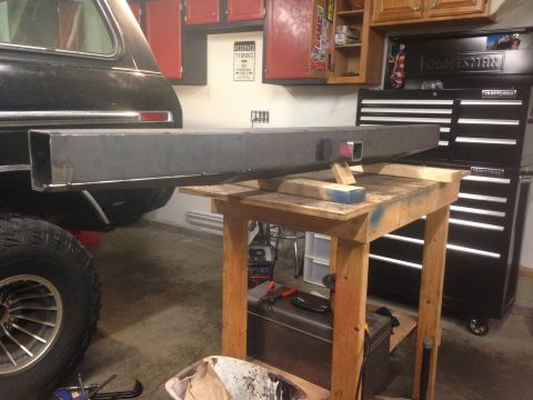1979 Ford Bronco - A custom steel bumper is mounted on a wooden workbench in front of a black 1979 Ford Bronco. A large black Craftsman toolbox is visible in…