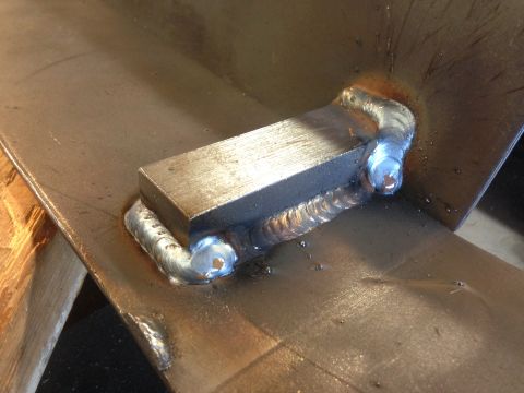 1979 Ford Bronco - A close-up shot shows a metal bracket welded onto a flat metal surface. The weld is visible with its characteristic bead and discoloration…
