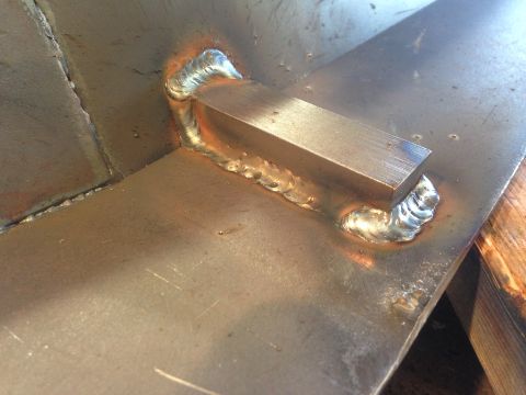 1979 Ford Bronco - A close-up shot shows a metal plate with a rectangular metal piece welded onto it. The welds are visible and appear to be recent.
