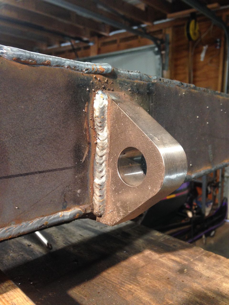 Welded metal bracket with a hole on a steel beam