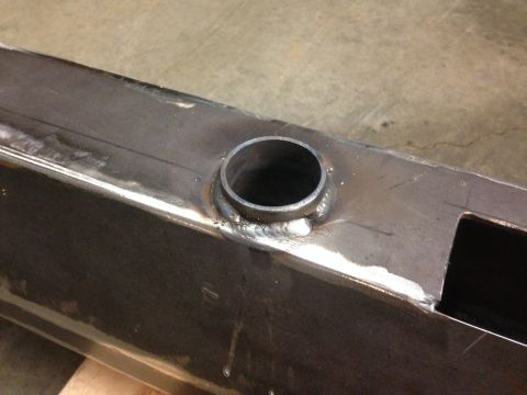 1979 Ford Bronco - A close-up shot shows a metal tube welded onto the top surface of a rectangular steel beam. The beam has a cut-out opening on its right sid…