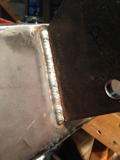 1979 Ford Bronco - A close-up view of a freshly applied weld joining two pieces of metal. The weld bead is prominent, showing a consistent pattern with some m…