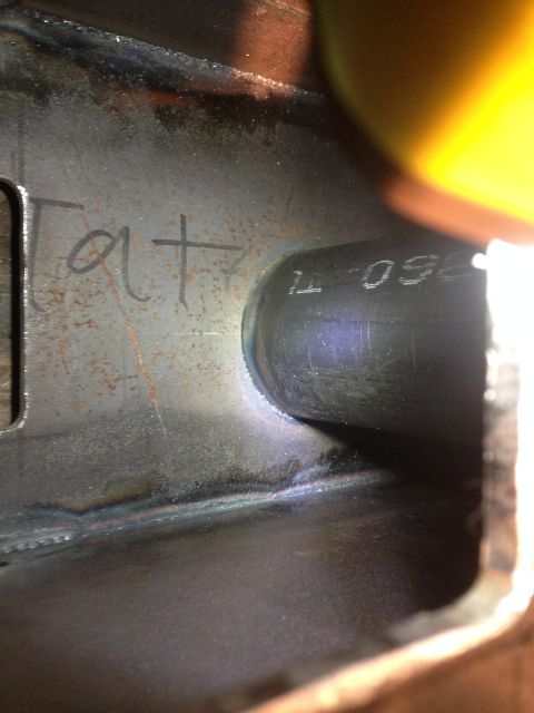 1979 Ford Bronco - A close-up view shows a metal component with handwritten text that reads "Tat" and stamped text "1L 099". The component appears to be part…