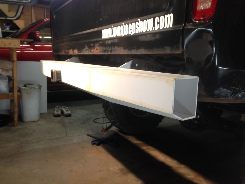 Custom rear bumper on a black Ford pickup truck with a website sticker on the tailgate.