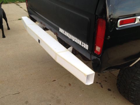 1979 Ford Bronco - The rear of a black 1979 Ford Bronco is shown with a white custom bumper extension attached.