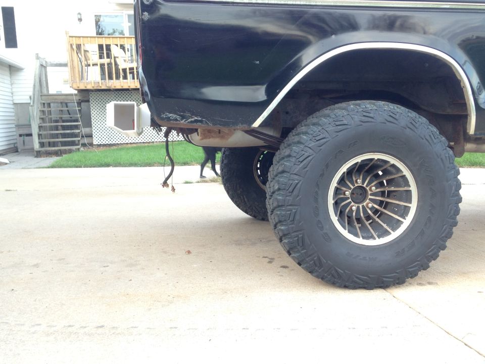 Black SUV rear wheel and fender with custom rims