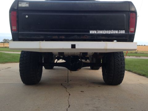 1979 Ford Bronco - Rear view of a 1979 Ford Bronco with a custom white bumper and off-road tires.