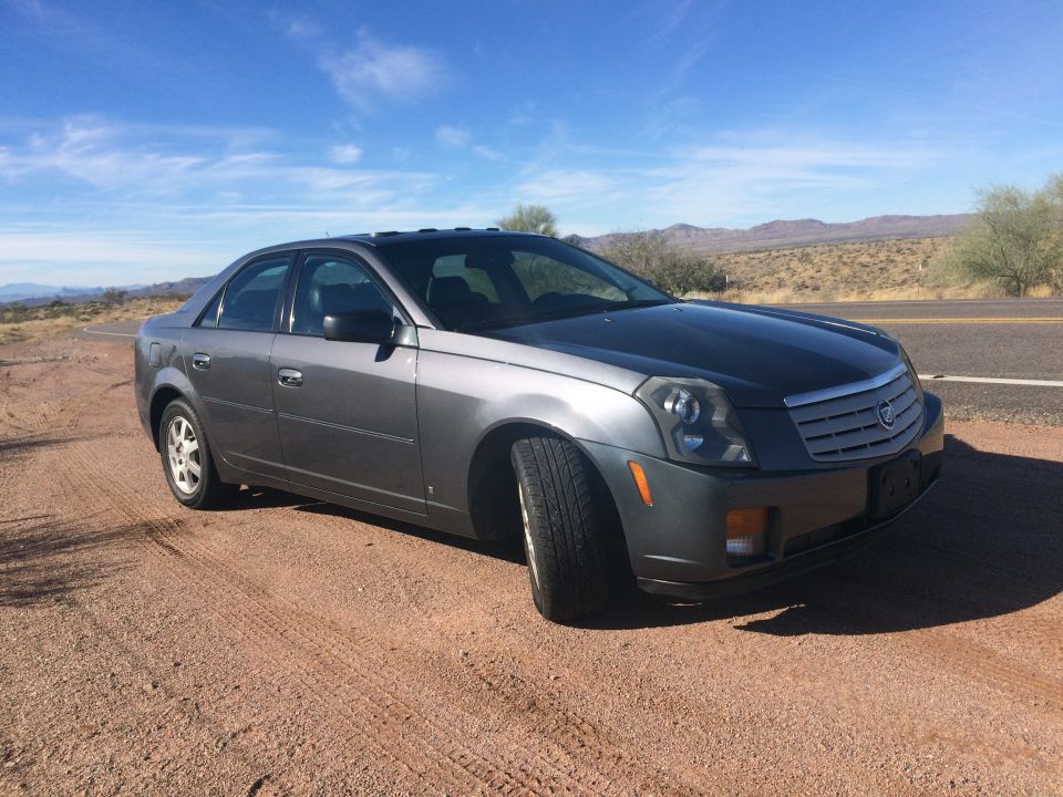 Gray 2007 Cadillac CTS 3q-front view parked on dirt road