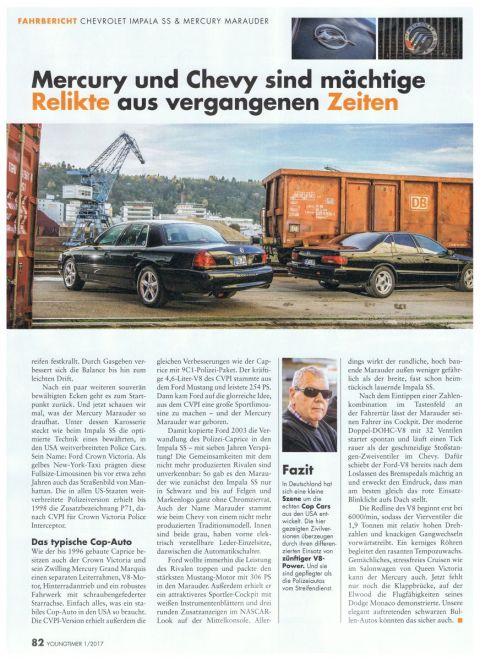 2003 Mercury Marauder - Two American sedans from the late 90s/early 2000s are parked in an industrial area next to a train car.