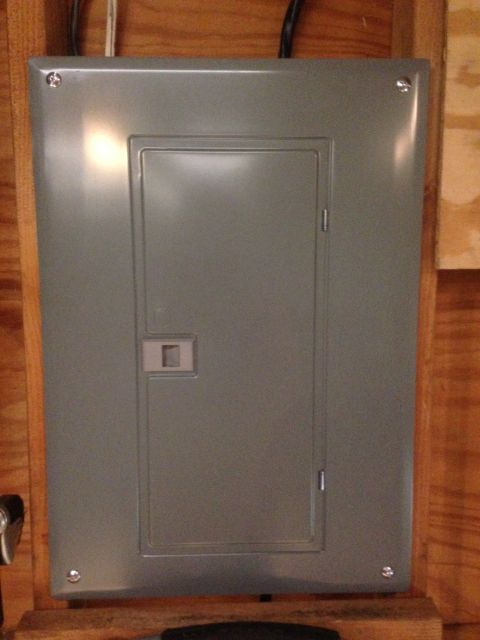 1979 Ford Bronco - Gray metal electrical panel with a small square handle on its door.
