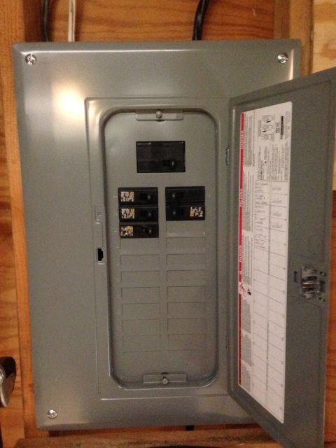 1979 Ford Bronco - An electrical panel with multiple circuit breakers and a service diagram on the inside of the door.