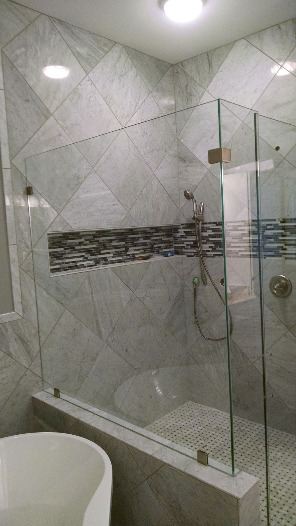 The shower enclosure was installed today, but they forgot the door sweep and handle, so they have to come back next week.