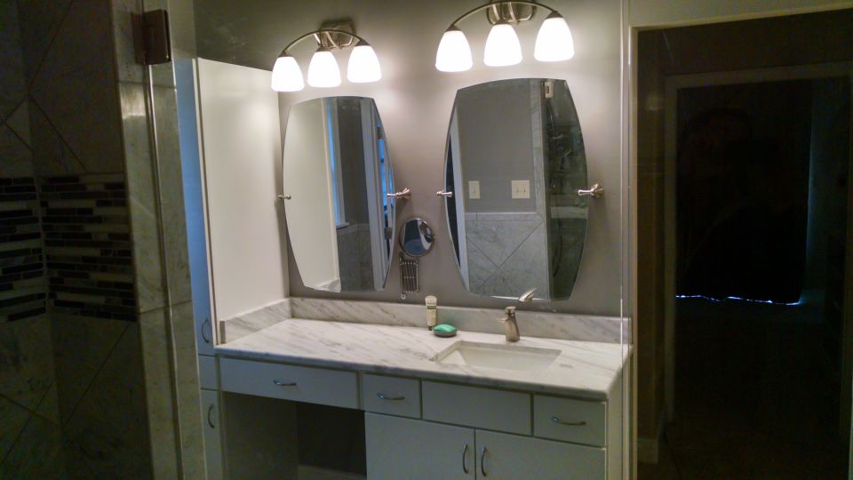 Her vanity has 2 swivelling mirrors & a telescoping magnifying mirror.  Her outlets are behind one of the mirrors (with USB power), and under the knee space, and inside her lower cabinet at the far Left (almost out-of-frame) for a pull-out rack with her hair dryer & curling iron.