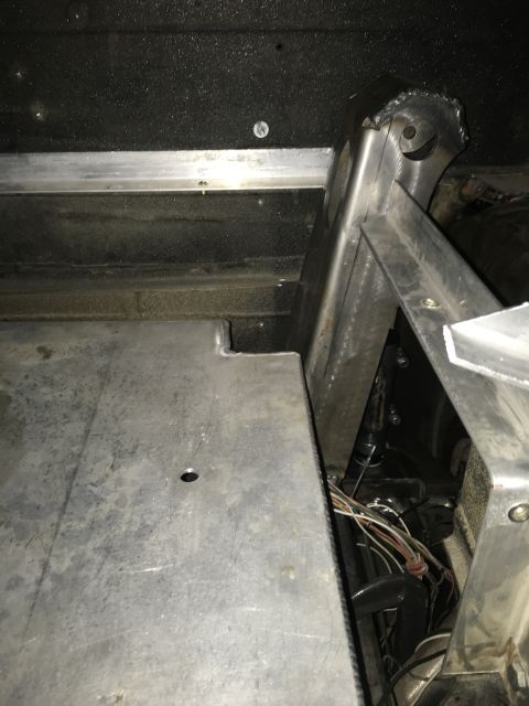 1961 International Scout 800 - A custom bracket is installed in a vehicle, showing wiring and metal construction.