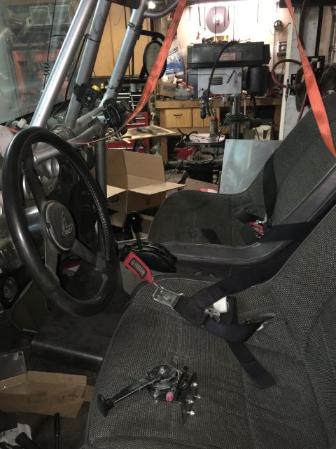 1961 International Scout 800 - The interior of a modified vehicle shows racing seats, a roll cage, and an aftermarket shifter, suggesting a custom build.