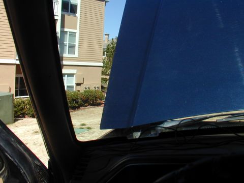 1988 Ford Bronco - View from inside vehicle, hood open. Building visible in background.