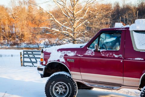 1995 Ford Bronco - 1995 Ford Bronco covered in snow during winter.