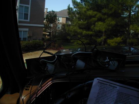 1988 Ford Bronco - A close-up view of a dashboard shows wiring and gauges, with an instruction sheet visible.