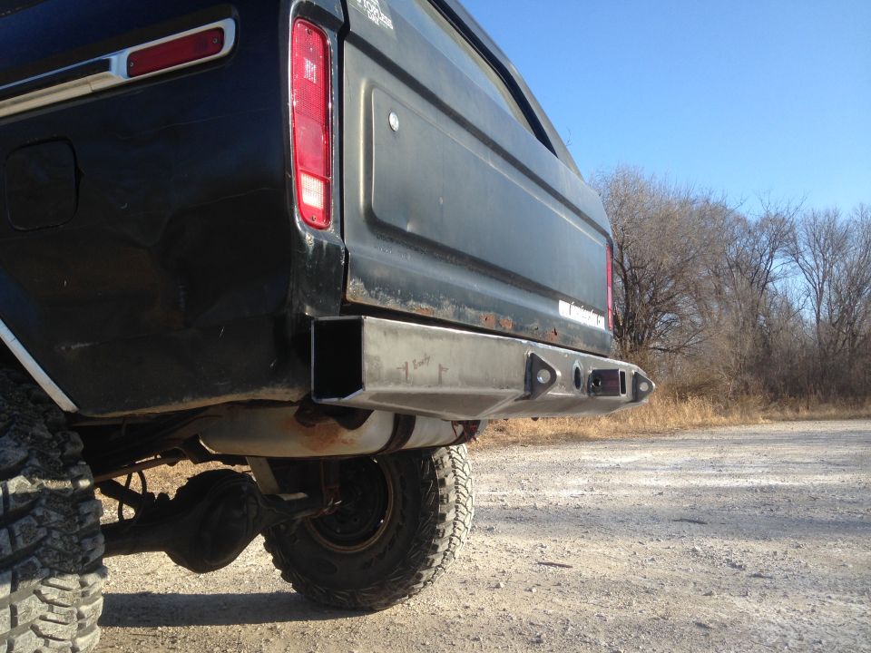 Black SUV rear with custom metal bumper and visible exhaust pipe