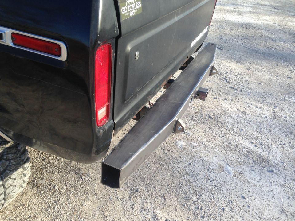Rear view of black 1979 Ford Bronco with custom bumper and trailer hitch
