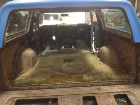 1979 Ford Bronco - The interior of a blue 1979 Ford Bronco is shown after the carpet has been removed.