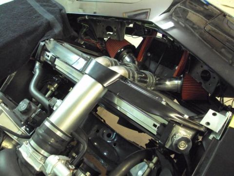 1976 Chevrolet Corvette - Custom engine bay modifications chrome intake piping and red air filters.