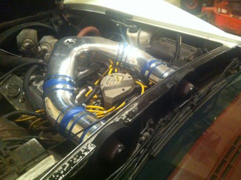 1976 Chevrolet Corvette - Custom chrome intake system installed in the engine bay, yellow spark plug wires and a prominent distributor cap.