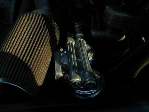 1988 Ford Bronco - Close-up of an engine compartment showing an air filter and chrome fuel rails.